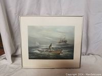 Frontal view of framed limited edition print depicting a fisherman handlining in a small boat with a fishing vessel behind, set against a moody gray and blue sea and sky.