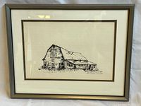 Frontal view of framed pen drawing depicting an old barn, with signature and location visible.