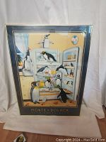 Front view of the framed print showing the full artwork with penguins and the refrigerator scene.