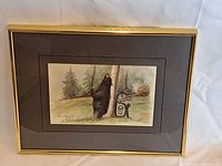 Framed art print shown in gold metal frame with double black mat.