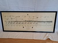Full frontal view of the framed poster showing the naval ships and cityscape illustration with the title text below.