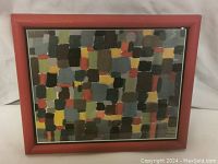 Frontal view of the framed mixed media abstract painting with colored rectangular swatches.