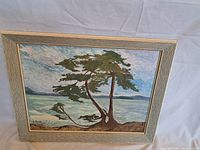 Framed oil on canvas painting showing the full artwork with tree and water landscape view.