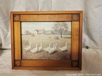 Full view of the framed print showing the entire artwork with farmhouse, geese, and trees in rustic wooden frame.