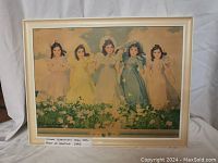 Photo of the full framed print showing five young girls in pastel dresses in a flower field.