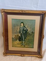 Full view of the gilt-framed print showing the subject and frame condition.