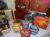 Photo showing a close-up assortment of various tins including holiday and cookie tins of different shapes and sizes.