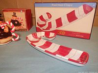 Photo showing Snowman Magic candy cane server platter and matching small dish with their boxes, alongside Gingermint Sweet Collection tea cup and teapot box.