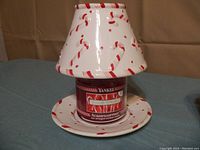 Yankee Candle candy cane plate with matching hurricane top featuring red and white candy cane stripes with a Housewarmer candle inside.