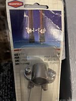 Photo showing one Mansfield ice script tip and its attachment screws in original packaging with visible brand and usage image.