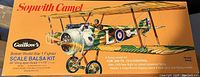 Box for Guillows Sopwith Camel balsa wood model aircraft kit. Box art shows British WW1 Sopwith Camel fighter airplane in camouflage paint with a pilot. Kit size and description on box.