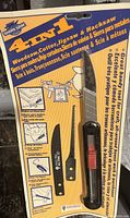 Photo of 4-in-1 saw set in original packaging, showing multiple blades and handle with usage instructions.