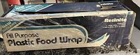 Box of Resinite All Purpose Plastic Food Wrap with large and smaller rolls inside.