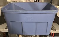 Photo of a large blue Rubbermaid plastic storage tote without a lid, showing a rectangular shape and reinforced sides.