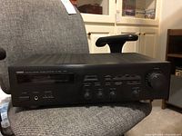 Yamaha R-S201 stereo receiver front view on chair