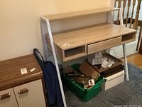 Full view of the desk showing metal frame, wood surfaces, drawer, and open compartments.