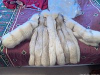 Coat laid flat showing front exterior, fur panels and overall shape.