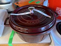 Closed pot showing burgundy enamel and Staub logo on lid