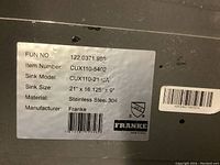 Label on bottom of sink showing model number CUX110-21-CA, dimensions 21 x 16.125 x 9 inches, material stainless steel 304, brand Franke.