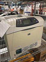 Front and angled side view of the HP LaserJet 4250n printer showing control panel and condition