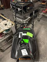 Front view of snow blower showing handlebar and housing