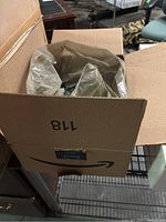 Cardboard Amazon Prime box unopened or partially opened, showing the package containing screws inside