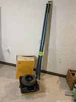 Full view of Kodak slide projector, Meteor 2 screen, and original box on carpeted floor.