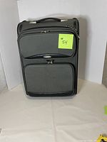 Grey Aero 20-inch luggage with multiple compartments and zippers.