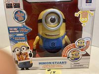 Minion Stuart laughing figurine in unopened original box with Despicable Me 2 branding seen from front.