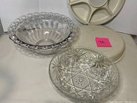 Photo showing all three items: two clear glass serving bowls with decorative edges and a vintage cream-colored Tupperware divided tray with lid.