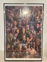 Framed Star Wars poster showing detailed character collage in a black frame.