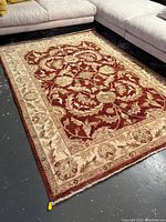 Full view of rug laid on floor showing overall pattern and condition