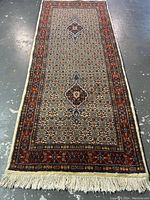 Full view of the rug laid flat on concrete floor