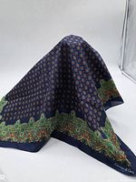 Italian silk scarf displayed draped to show overall color and pattern including the detailed border design.