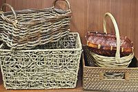 Photo showing five wicker baskets stacked and nested, varying in size and weave style.