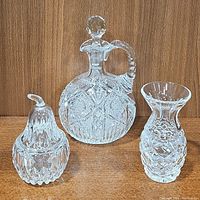 All three items together: cut glass decanter with stopper, pear-shaped dish, crystal fluted vase