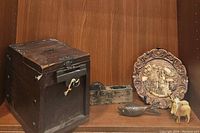 Overall lot arrangement showing Tansu box, sumitsubo, wood carved plate, fish bottle opener, wooden cow figurines