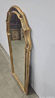 Full view of the standing mirror showing the arched top and overall shape