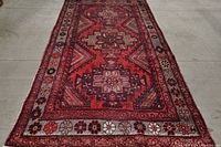 Full view of the red Moroccan style area rug showing overall pattern and dimensions