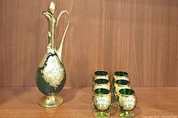 Decanter and six glasses displayed together on wooden surface showing the complete set
