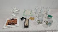 Full collection of Irish dishes, mugs, plaques, cookbook, and peat moss box arranged on a table