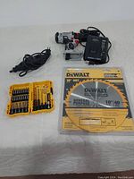 Photo of Craftsman rotary tool, yellow DeWalt screwdriver bit set, DeWalt 10'' 40T saw blade