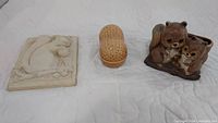 Full view of all three items: plaster squirrel plaque, peanut trinket box, and chipmunk planter