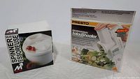 Photo showing two boxes: one for Metro salad spinner and one for Presto professional salad shooter.