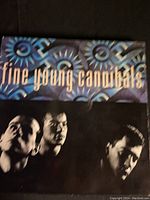Fine Young Cannibals self-titled album cover showing band members' image with stylized band name.