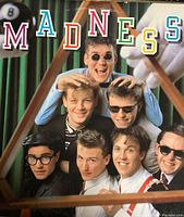 Vinyl album cover with the band Madness posing playfully with colorful lettering spelling 'MADNESS'