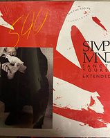 Vinyl record cover with red and white abstract design and photo of person, featuring Simple Minds text and album/song titles.