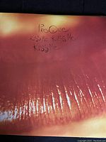 Front album cover showing close-up of lips with handwritten album title 'The Cure Kiss Me Kiss Me Kiss Me'.