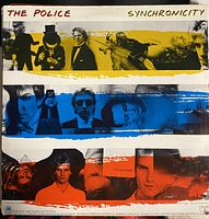 Colorful cover of The Police Synchronicity vinyl album with horizontal stripes of yellow, blue, and red and various band member images