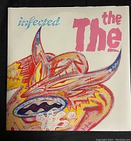 Front cover of The The's Infected album with colorful abstract face artwork.